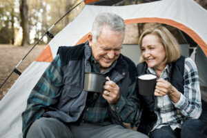 happy elderly couple having coffee by the tent in 2025 02 10 02 26 49 utc 2