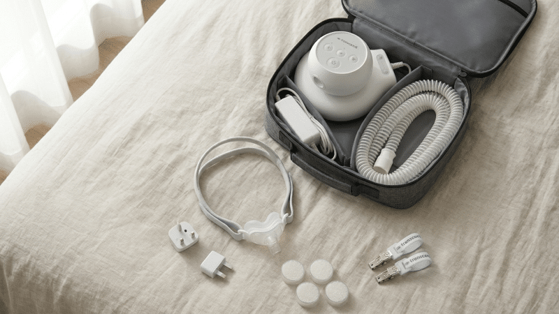 compact cpap machine with power adapters and travel bag